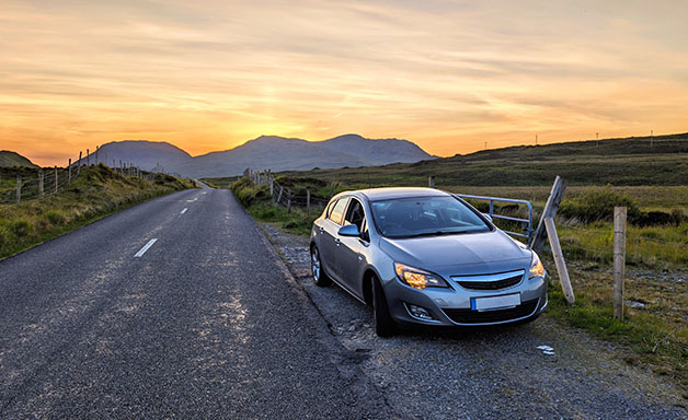 car parked of small rural county road in mountain area