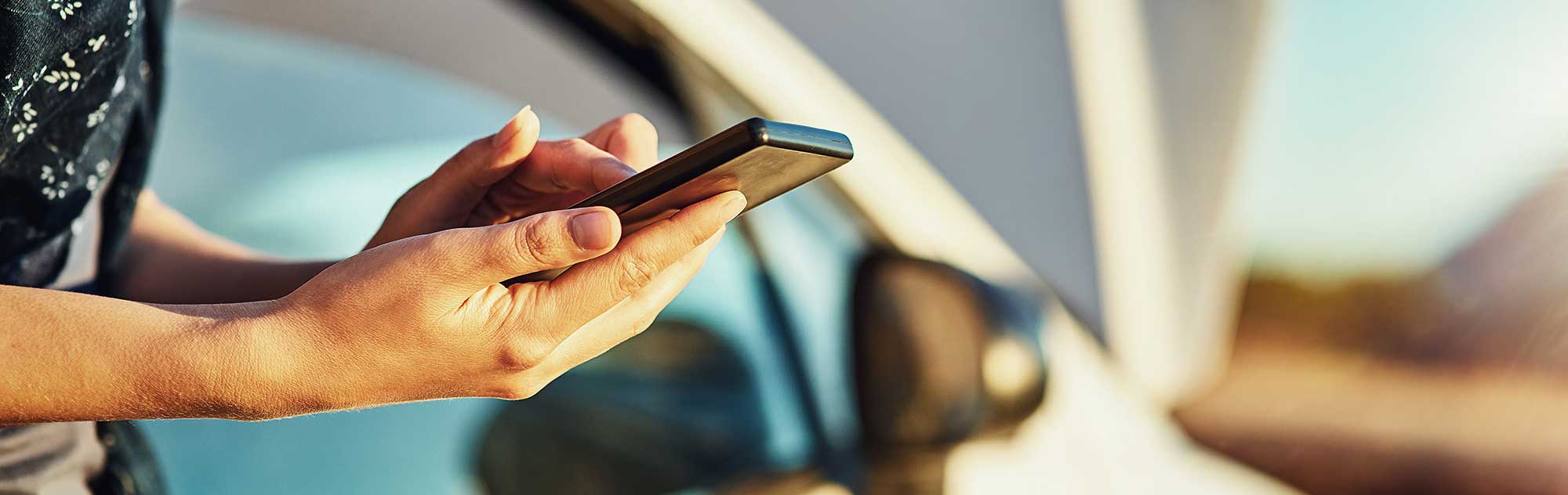 Cropped shot of an unidentifiable woman contacting roadside assistance after breaking down