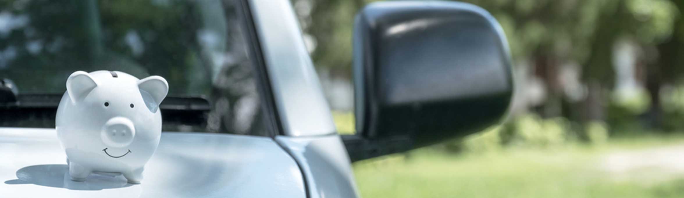  A piggy bank sitting on a car